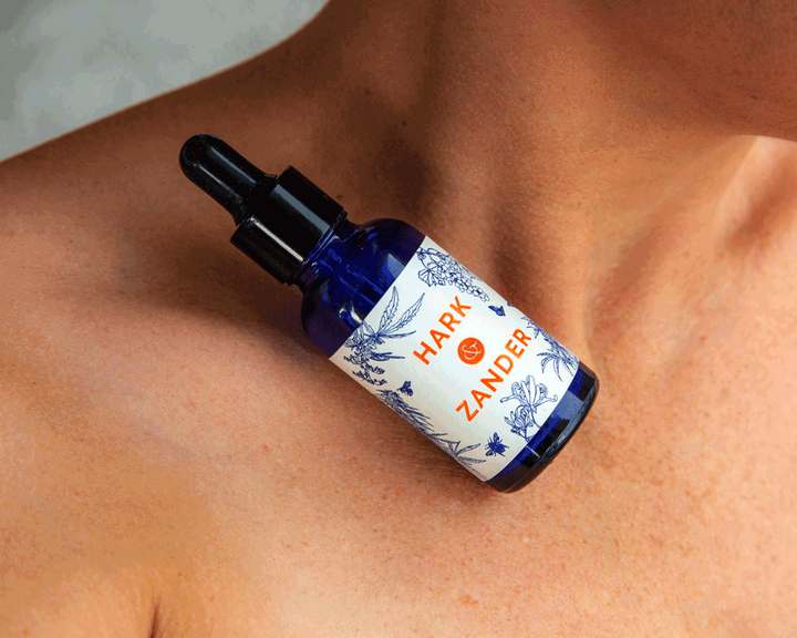Bottle of Hark & Zander product on a person's shoulder